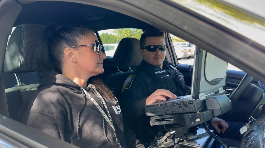 Peer Recovery Specialist Joy Bogese and Officer Travis Adams conversing on a ride along. Credit: Rolynn Wilson for WRIC ABC 8News.